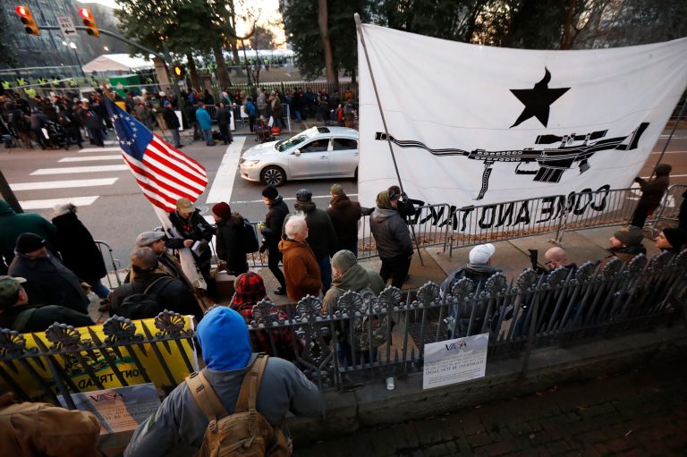 People line up outside the capitol before a pro gun rally, Monday, Jan. 20, 2020, in Richmond, Va.