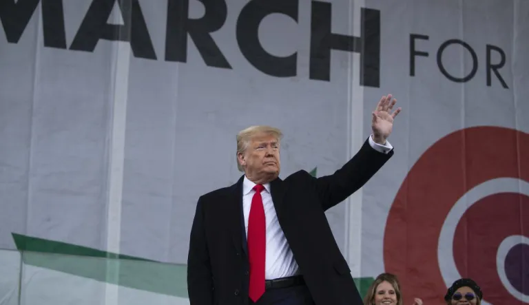President Donald Trump waves after speaking during the annual 