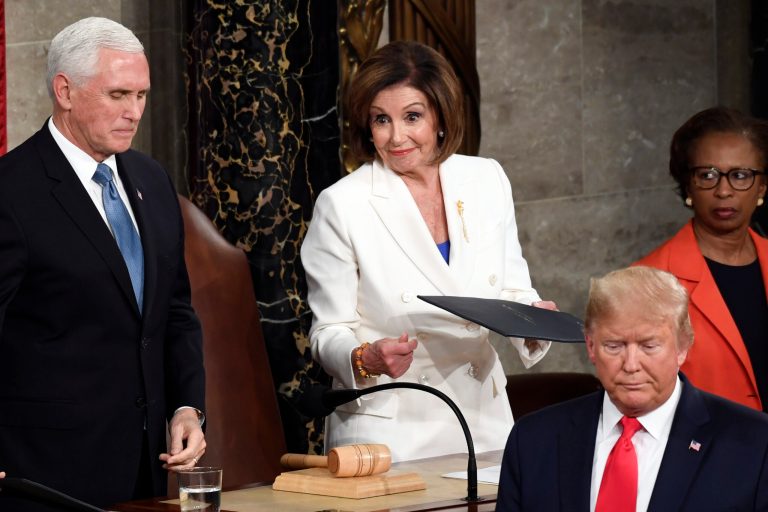 President Donald Trump turns after handing copies of his speech to House Speaker Nancy Pelosi of Calif., and Vice President Mike Pence as he delivers his State of the Union address to a joint session of Congress on Capitol Hill in Washington Feb. 4, 2020.  She's been claiming that Russians "have" something on Trump.