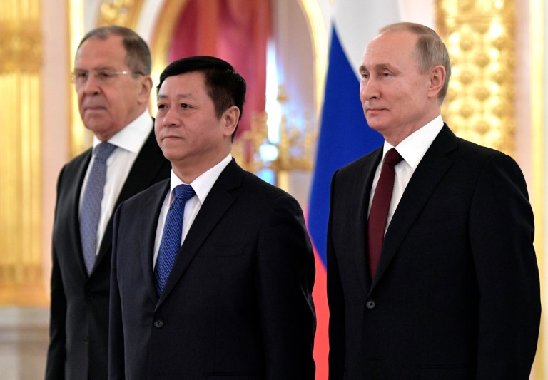 China's Ambassador to Russia, Zhang Hanhui, centre, poses after presenting his diplomatic credentials with Russian President Vladimir Putin, right, and Russian Foreign Minister Sergei Lavrov during a ceremony to receive credentials from newly appointed foreign ambassadors to Russia in Kremlin, in Moscow, Russia, Wednesday, Feb. 5, 2020. Zhang called the United States 