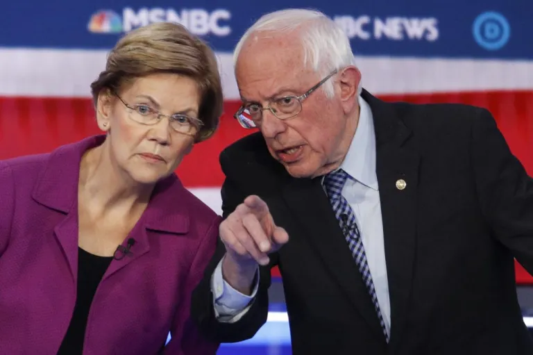 Democratic presidential candidates, Sen. Elizabeth Warren, D-Mass., left, and Sen. Bernie Sanders, I-Vt., talk during a Democratic presidential primary debate Wednesday, Feb. 19, 2020, in Las Vegas. A new poll said they could win the White House.
