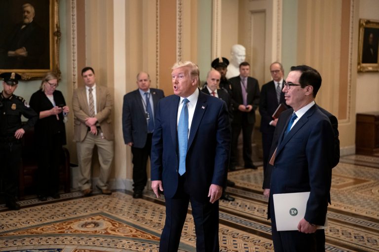 President Donald Trump, joined by Treasury Secretary Steven Mnuchin, right, speaks to reporters after meeting with Republican senators, on Capitol Hill in Washington, Tuesday, March 10, 2020. Trump wants Congress to pass payroll tax relief as he looks to calm financial markets' fears over the impact of the coronavirus epidemic.
