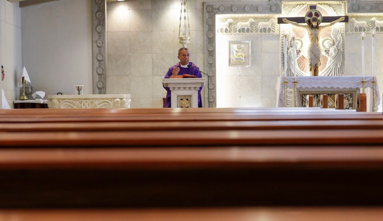 Catholic priest Rymond Ratilla gestures during his sermon at a livestreamed Mass in an empty Chapel of the Nativity of the Blessed Virgin Mary in Cubao, Quezon City, Philippines. 