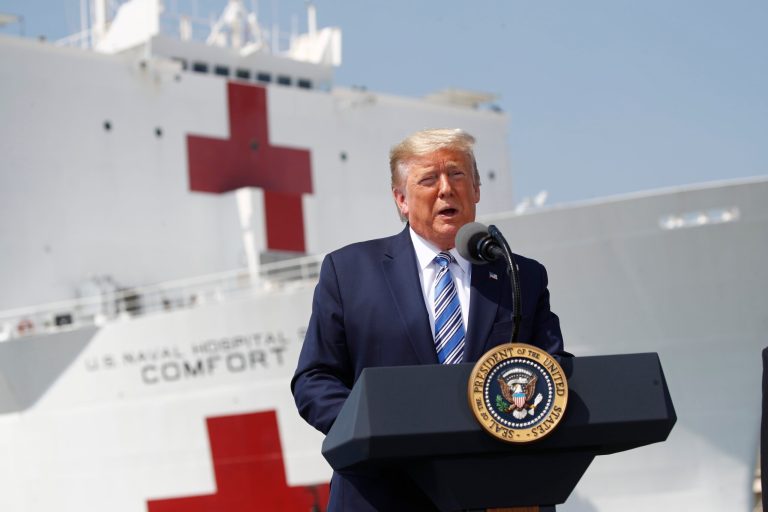President Donald Trump speaks in front of the U.S. Navy hospital ship USNS Comfort at Naval Station Norfolk in Norfolk, Va., Saturday, minutes before the suip left for New York City to assist hospitals responding to the coronavirus outbreak.