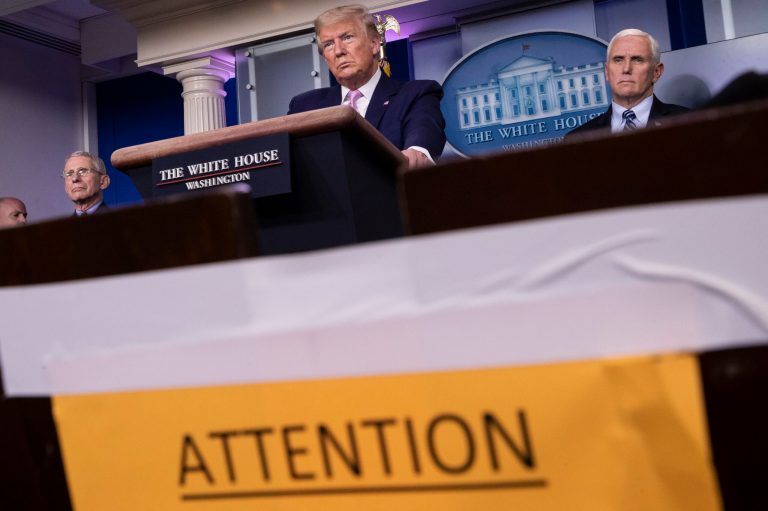 President Donald Trump speaks, accompanied by Dr. Anthony Fauci, director of the National Institute of Allergy and Infectious Diseases, left, and Vice President Mike Pence about the coronavirus Wednesday.