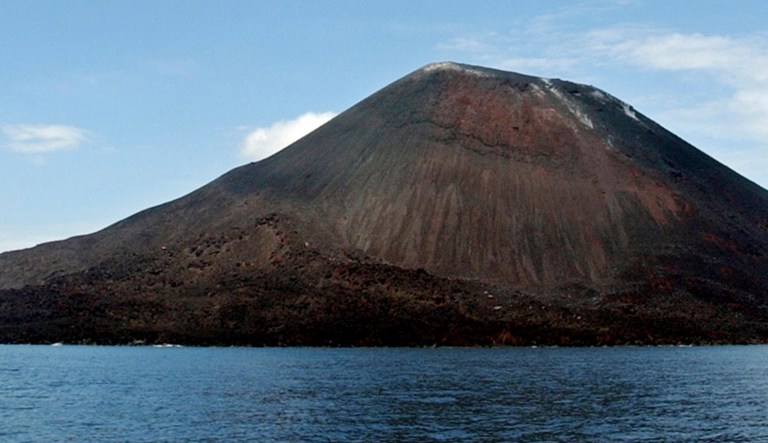 This April 10, 2004 file photo shows the volcano, Anak Krakatau, seen from the coast of West Java, Indonesia. Indonesiaâs Anak Krakatau in Lampung erupted on Friday night, April 10, 2020,  Indonesiaâs volcanology agency said the eruption is spewing the column of ash up to 500 meter high.