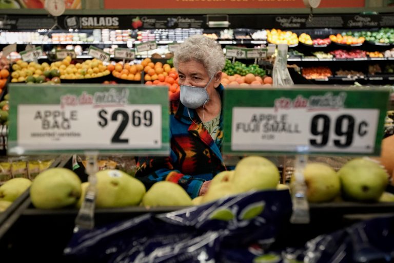 In this March 17, 2020, file photo, Carmen Zamora shops at Northgate GonzÃ¡lez Market in Santa Ana, California, during an early-hour shopping time for those over 65 and the disabled.