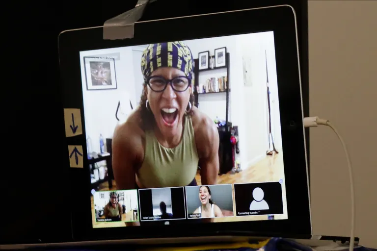 Fitness instructor Tamara Jackson, top of screen, teaches a fitness class through Zoom, an online meeting platform, Saturday, April 25, 2020, in New York. A new business survey shows many workers want to remain working from home.