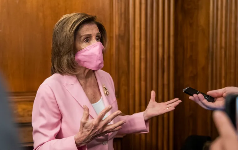 House Speaker Nancy Pelosi of Calif., talks to reporters on Capitol Hill, Tuesday. A new survey finds Democrats are more depressed over the virus, in part because they feel public officials haven't done enough to fight it.