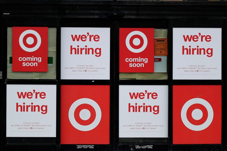Hiring signs are displayed at a Target store in Chicago, Thursday, May 28, 2020. Adults appear to be happy about their personal finances and their future.