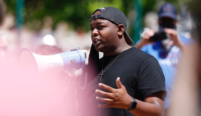 Tay Anderson, Denver School Board at large director, uses a bullhorn to speak during a protest outside the State Capitol over the death of George Floyd, a handcuffed black man in police custody in Minneapolis, Friday, May 29, 2020, in Denver.