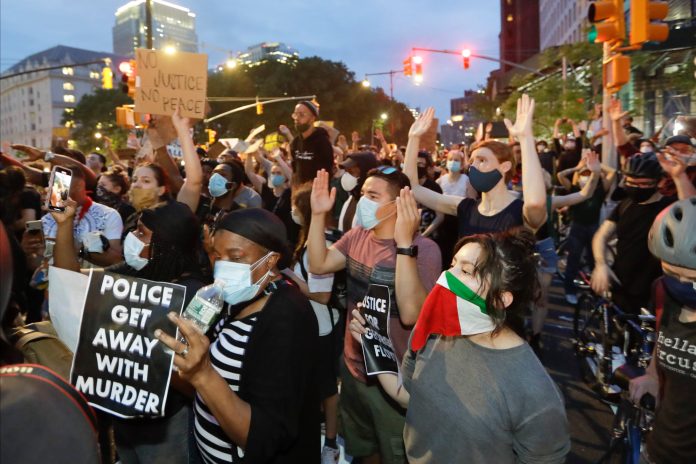 Protesters confront New York Police officers as part of a solidarity rally calling for justice over the death of George Floyd, Wednesday, June 3, 2020, in the Brooklyn borough of New York.