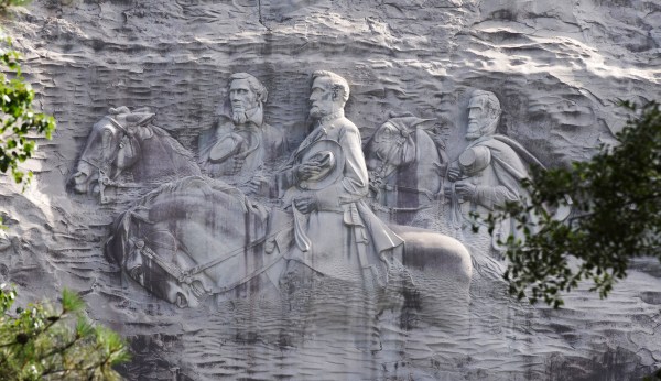 Armed protesters demonstrate in front of Confederate carving on Stone Mountain