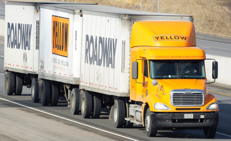 FILE - In this Feb. 2, 2010, file photo, a Yellow Freight/Roadway Express truck travels east on I-70, near Lecompton, Kan. (AP Photo/Orlin Wagner, File)
