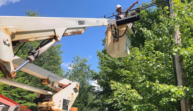 A Consolidated Communications technician works on a line used to provide broadband internet service in a rural area on Wednesday, July 29, 2020, in Stowe, Vt. Vermont officials are working to expand internet service using federal pandemic relief funds. But they are scrambling because the projects, which can frequently take years to plan and build, must be done by the end of the year.