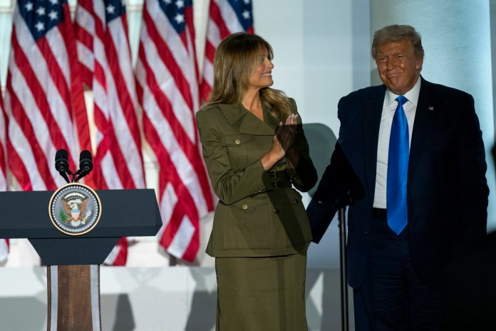 President Donald Trump joins first lady Melania Trump on stage after her speech to the 2020 Republican National Convention from the Rose Garden of the White House Tuesday.