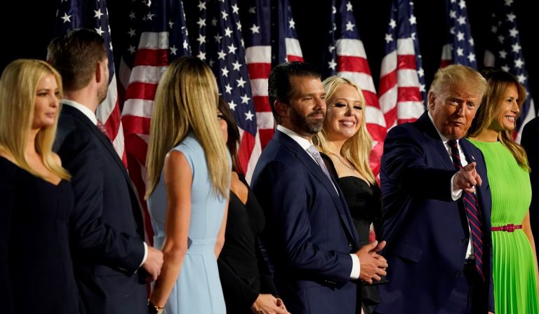 From left, Ivanka Trump, Eric and Lara Trump, Kimberly Guilfoyle and Donald Trump Jr., Tiffany Trump, President Donald Trump and first lady Melania Trump and Barron Trump stand on stage on the South Lawn of the White House on the fourth day of the Republican National Convention.