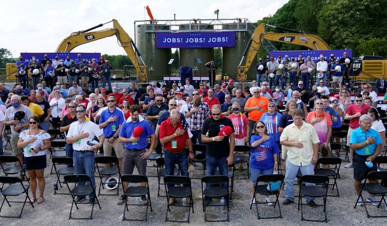 People pray and recite the Pledge of Allegiance before Vice President Mike Pence arrives to speak at a campaign event at a PennEnergy Resources site on Wednesday Sept. 9. 2020, in Freedom, Pa.