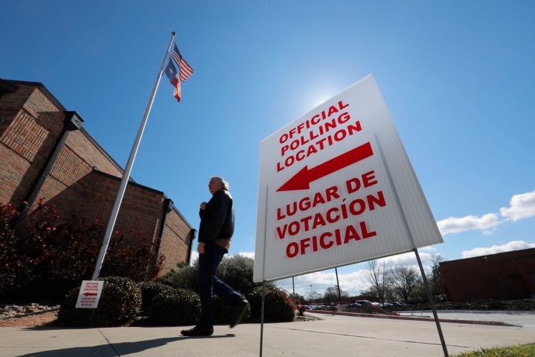 A Dallas sign in English and Spanish points potential voters to an official polling location during early voting.