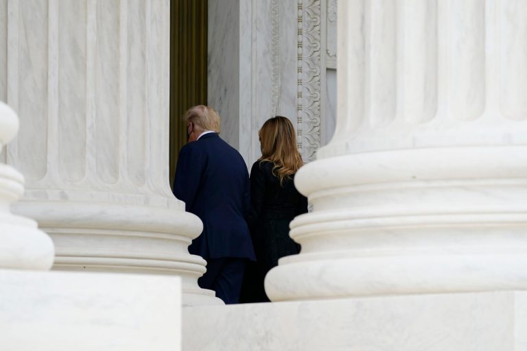 President Donald Trump, left, and First Lady Melania Trump, walk away after paying respects to Justice Ruth Bader Ginsburg on Thursday, Sept. 24 2020, in Washington. (AP Photo/Alex Brandon, Pool)