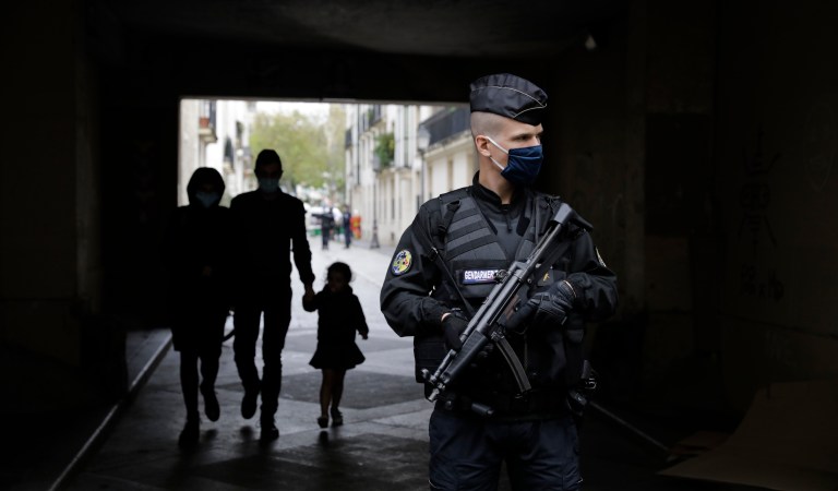 A French gendarme guards a street after a knife attack near the former offices of satirical newspaper Charlie Hebdo, Friday Sept. 25, 2020 in Paris. French terrorism authorities are investigating a stabbing of two people Friday outside the former offices of the satirical newspaper Charlie Hebdo in Paris, and two suspects have been arrested, authorities said. France's counterterrorism prosecutor said authorities suspect a terrorist motive because of the place and timing of the stabbing: in front of the building where Charlie Hebdo was based until the 2015 Islamic extremist attack on the newspaper's cartoonists that killed 12 people, and at a time when the trial into that attack is under way across town.