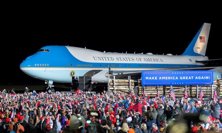 The crowd cheers as Air Force One arrives with President Donald Trump at Duluth International Airport for Trump's campaign appearance in Duluth, Minn, on Wednesday.