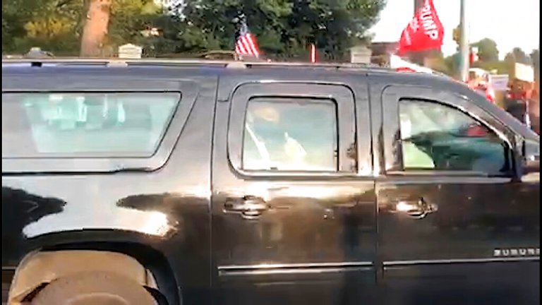 Masked Trump salutes fans outside Walter Reed hospital in motorcade drive-by