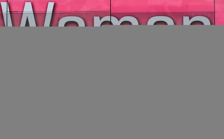 Voters stand in front of the bus in support of Women For Trump outside the Hamilton County Board of Elections as people arrive to participate in early voting in Norwood, Ohio