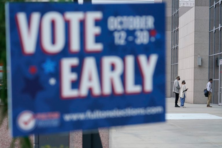 A line forms outside of the State Farm Arena for early voting on Monday in Atlanta.