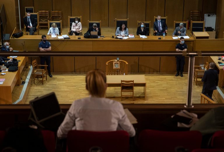 A view of the court during the sentencing announcement of the Golden Dawn trial, in Athens, Wednesday, Oct. 14, 2020. The court has sentenced the leadership of Greece's extreme-right Golden Dawn party to 13 years in prison, imposing the near-maximum penalty for running a criminal organization blamed for numerous violent hate crimes. The landmark ruling follows a five-year trial of dozens of top officials, members, and supporters of Golden Dawn, an organization founded as a Neo-Nazi group in the 1980s, that rose to become Greece's third-largest political during a major financial crisis in the previous decade.(AP Photo/Petros Giannakouris)