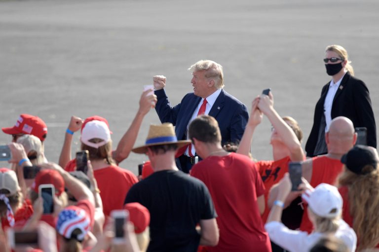 President Donald Trump acknowledges supporters after arriving to a campaign rally at the Ocala International Airport, Friday, Oct. 16, 2020, in Ocala, Fla.