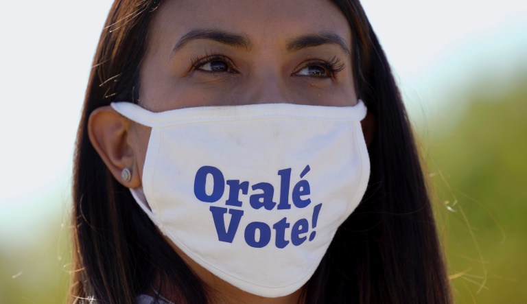 A supporter of Democratic vice presidential candidate Sen. Kamala Harris, D-Calif., listens to her speak at a campaign event Friday, Oct. 30, 2020, in Fort Worth, Texas. 