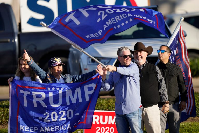 Supporters of President Trump cheer as passing cars honk their horns near a polling location on Election Day, Tuesday, Nov. 3, 2020, in Houston.