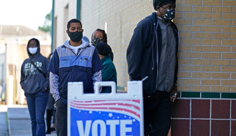 People line up to vote on election day at the Matin Luther King, Jr. Elementary School, in the Lower Ninth Ward of New Orleans, Tuesday, Nov. 3, 2020.