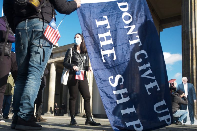 People attend a rally of the organization Democrats abroad after the election in the United States, in Berlin, Germany, Wednesday, Nov. 4, 2020. The demonstrators demand that all votes have to count at the United States elections. At home, both sides are in a new fundraising frenzy to fund legal battles.