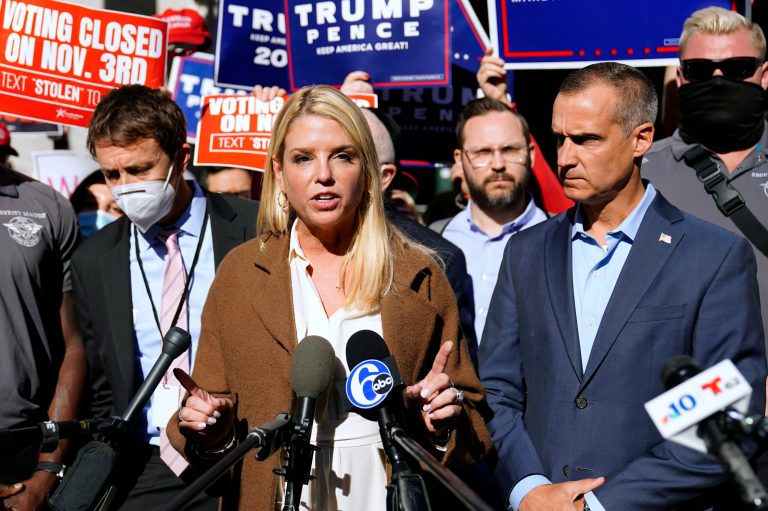 Former Florida Attorney General Pam Bondi speaks outside the Pennsylvania Convention Center where votes are being counted, Thursday, Nov. 5, 2020, in Philadelphia, following Tuesday's election. At right is President Donald Trump's campaign advisor Corey Lewandowski.