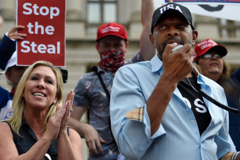 President Donald Trump supporters cheer as Georgia State Rep. Vernon Jones speaks, accompanied by Republican Congresswoman-elect Marjorie Taylor Greene, Saturday, Nov. 7, 2020, in Atlanta.