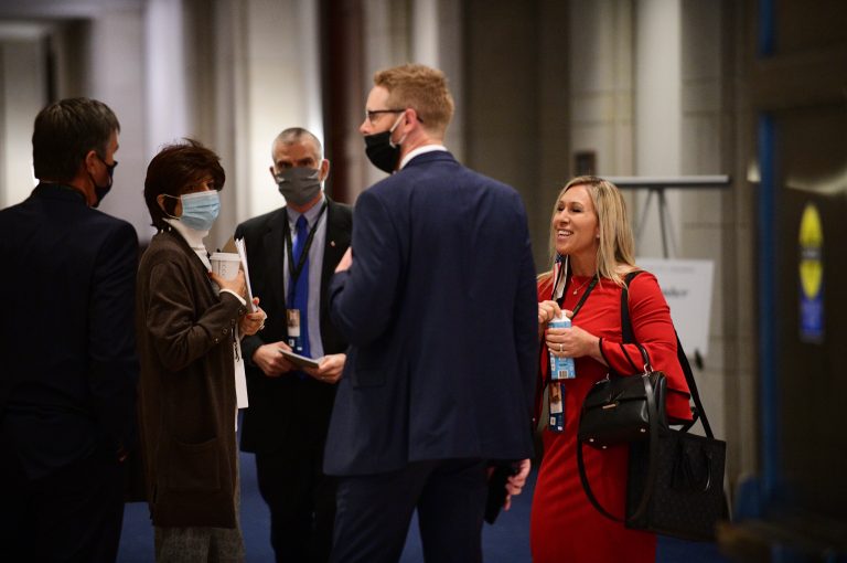 Rep.-elect Marjorie Taylor Greene, R-Ga., right, joins other for a chat during a Congressional orientation on Capitol Hill in Washington, Friday, Nov. 13, 2020. She is taking the lead among those fighting a House mask mandate.
