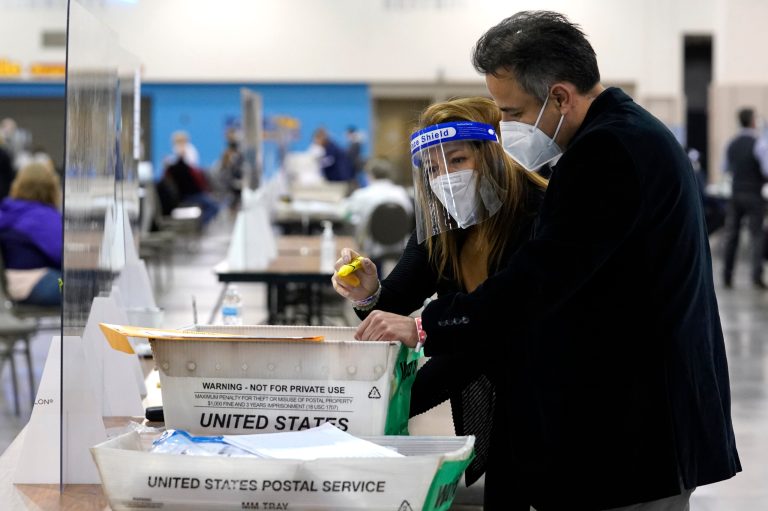 Election workers check ballots during a Milwaukee hand recount of presidential votes at the Wisconsin Center, Friday, Nov. 20, 2020, in Milwaukee, Wis. The recount of the presidential election in Wisconsin's two most heavily Democratic counties confirmed Joe Biden's victory.