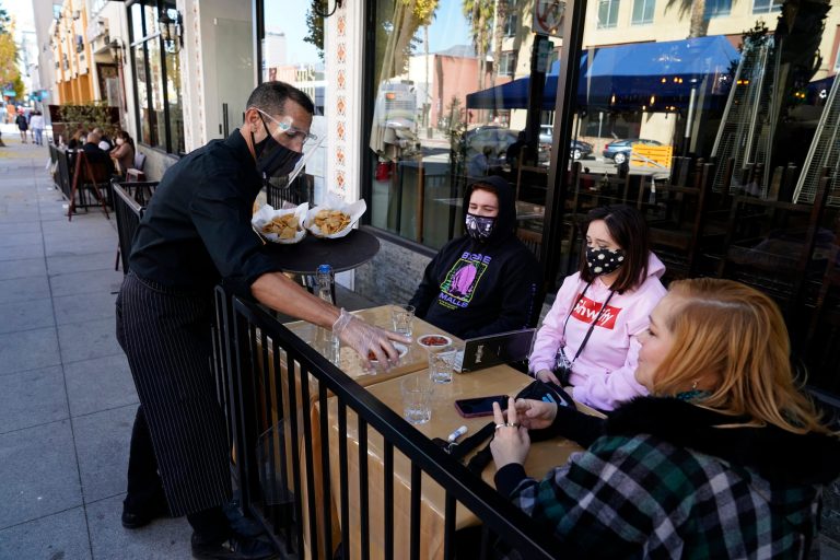 Customers are served lunch at an outdoor seating space in Pasadena, Calif. last week. The nation's largest county acted "arbitrarily" when it banned outdoor dining at restaurants during the coronavirus pandemic, a Los Angeles judge tentatively ruled Tuesday, Dec. 8, 2020, in a case that could have implications for other California businesses struggling during the state shutdown.