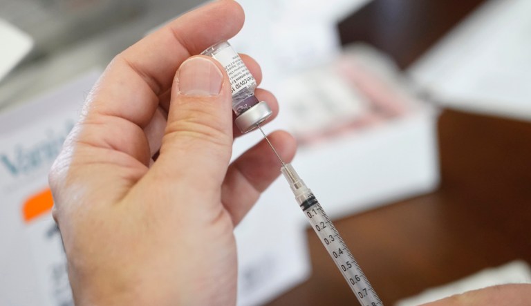 Walgreens pharmacist Chris McLaurin prepare to fill a syringe with Pfizer-BioNTech COVID-19 vaccine before vaccinating the residents at Harmony Court Assisted Living, Tuesday, Jan. 12, 2021, in Jackson, Miss.