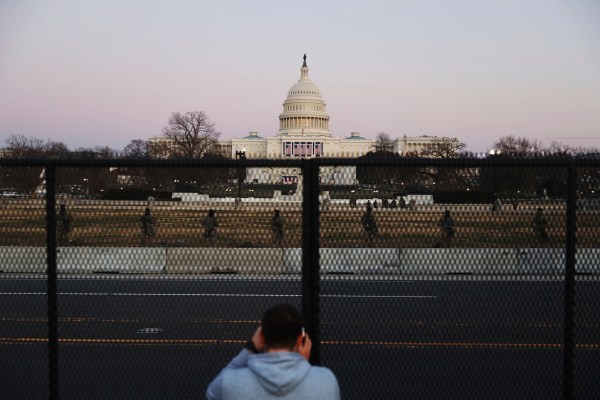 Two off-duty police officers pictured giving the middle finger during Capitol siege arrested