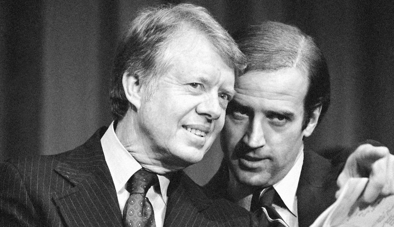 In this Feb. 20, 1978, file photo, President Jimmy Carter listens to Sen. Joseph R. Biden, D-Del., as they wait to speak at a fundraising reception at Padua Academy in Wilmington, Del. 