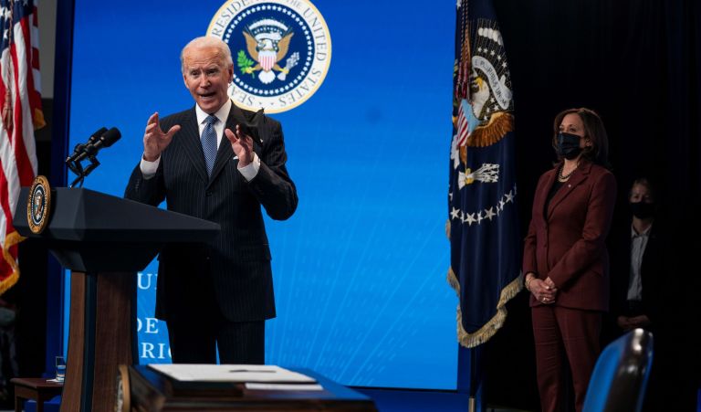 Vice President Kamala Harris listens as President Joe Biden answers questions from reporters in the South Court Auditorium on the White House complex