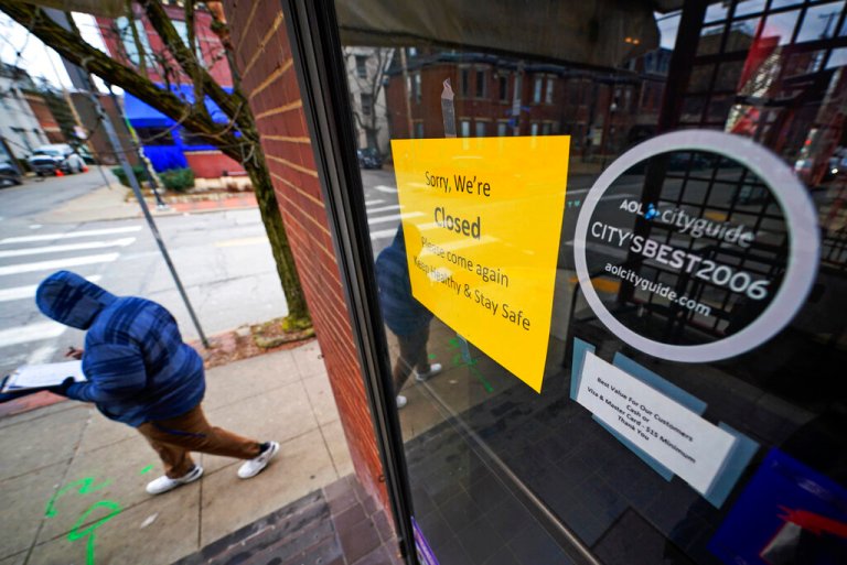 A sign hangs on the door of the Union Grill, temporarily closed due to COVID-19, in the Oakland neighborhood of Pittsburgh on Thursday, Jan. 28, 2021.