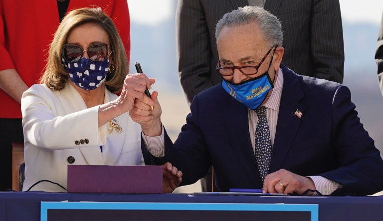 In this March 10, 2021, file photo House Speaker Nancy Pelosi of Calif., and Senate Majority Leader Chuck Schumer of N.Y., pose after signing the $1.9 trillion COVID-19 relief bill during an enrollment ceremony on Capitol Hill in Washington.