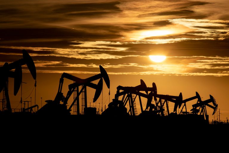 FILE - In this Tuesday, Feb. 2, 2020, file photo, pump jacks operate in an oilfield as the sun begins to set on the horizon in Midland, Texas. (Jacob Ford/Odessa American via AP, File)