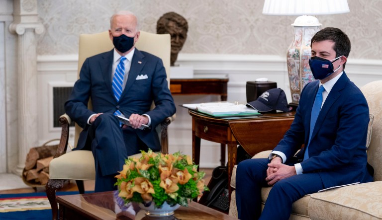In this March 4, 2021, file photo, President Joe Biden and Transportation Secretary Pete Buttigieg, right, meet with Vice President Kamala Harris and members of the House of Representatives in the Oval Office of the White House in Washington, on infrastructure. Two months into his job, Buttigieg is forging a fresh path for his Cabinet role and in his life that could bridge gaps with Republicans when it comes to Bidenâs agenda.