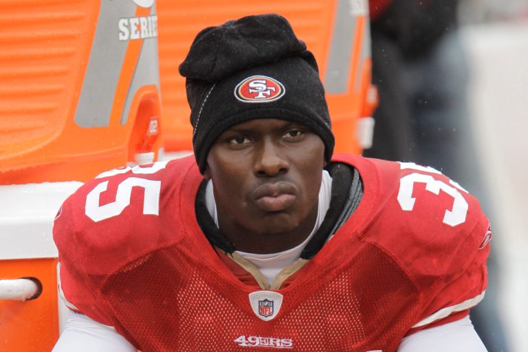 FILE - In this Oct. 17, 2010 file photo, San Francisco 49ers cornerback Phillip Adams sits on the sideline during the first quarter of an NFL football game in San Francisco.