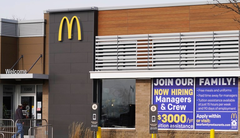 A hiring sign is seen outside of McDonald in Buffalo Grove, Ill., Thursday, Nov. 19, 2020.The number of applications for unemployment benefits rose sharply last week, indicating continued challenges for the U.S. economic recovery as coronavirus infections increased around the country.